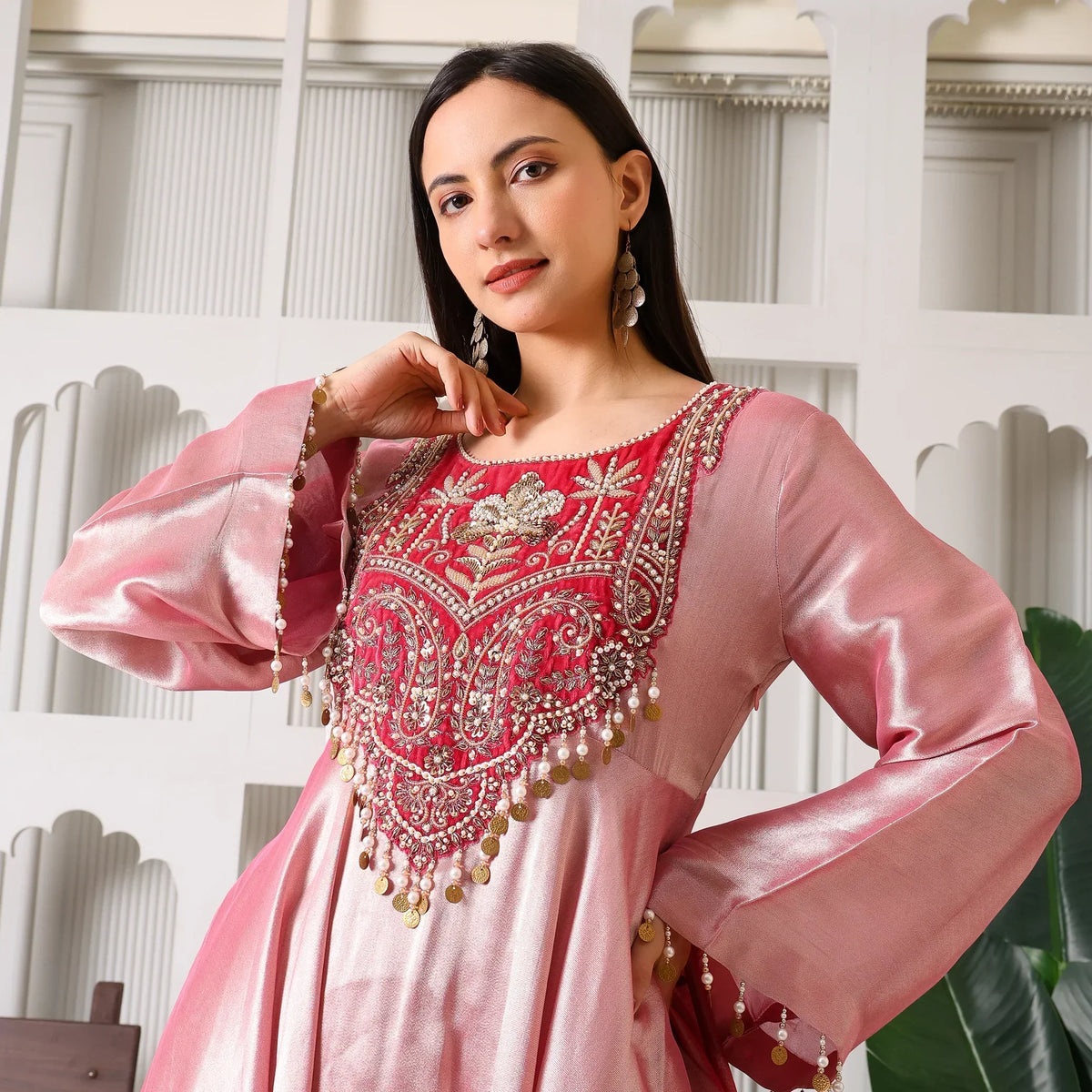 Woman in a pink Banarasi Anarkali suit with intricate embroidery and beadwork
