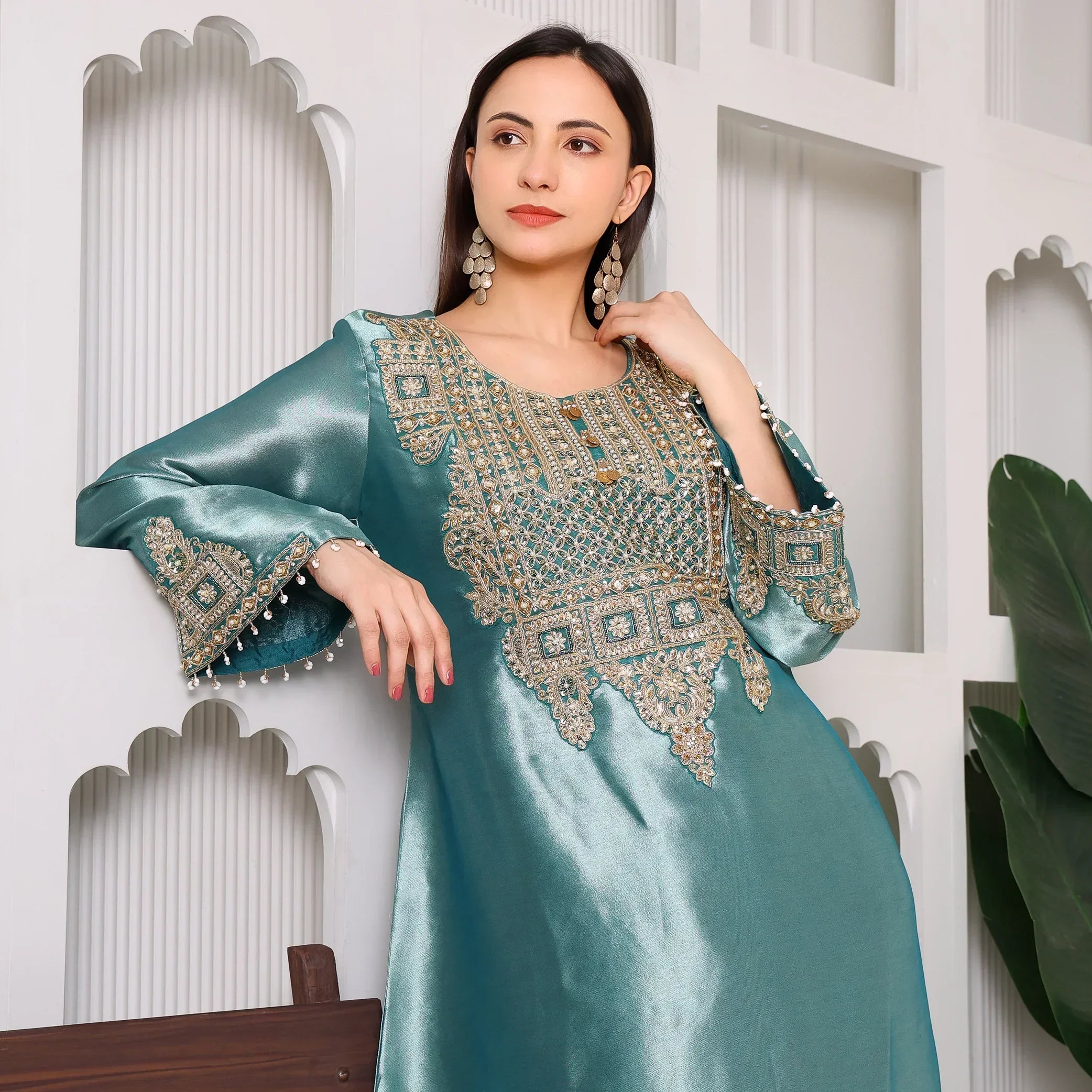 Woman wearing teal Banarasi Anarkali suit with intricate gold embroidery, festive ethnic fashion