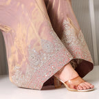 Close-up of pastel Banarasi suit pants with intricate silver embroidery and transparent heels