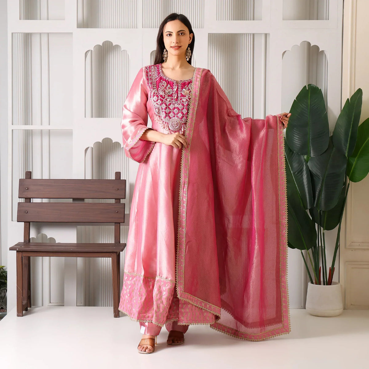 Woman in pink Banarasi Anarkali suit with embroidered dupatta, festive ethnic wear