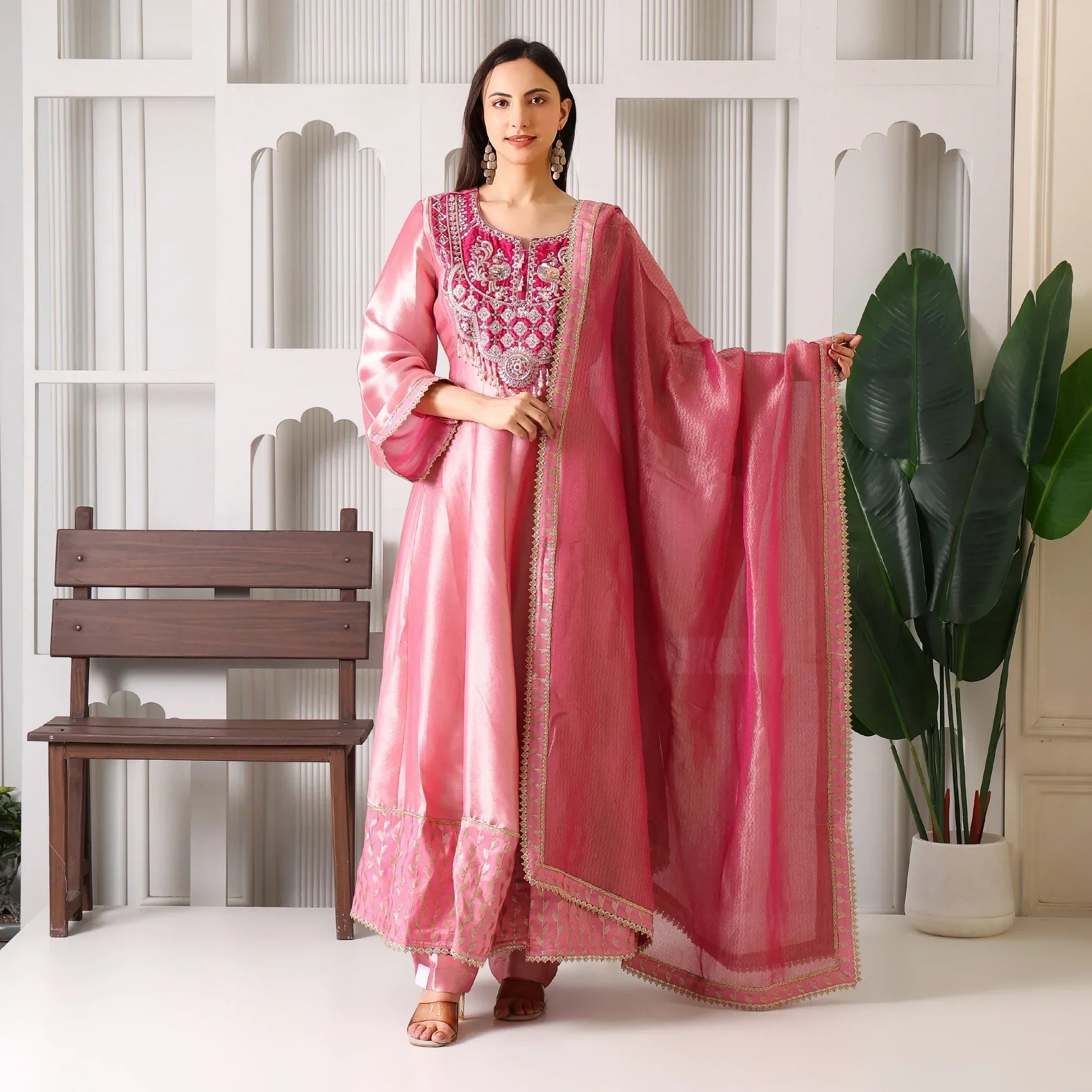Woman in pink Banarasi Anarkali suit with embroidered dupatta, festive ethnic wear