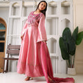 Woman wearing pink Banarasi Anarkali suit with embroidered yoke, holding matching dupatta