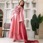 Woman wearing pink Banarasi Anarkali suit with embroidered yoke, holding matching dupatta