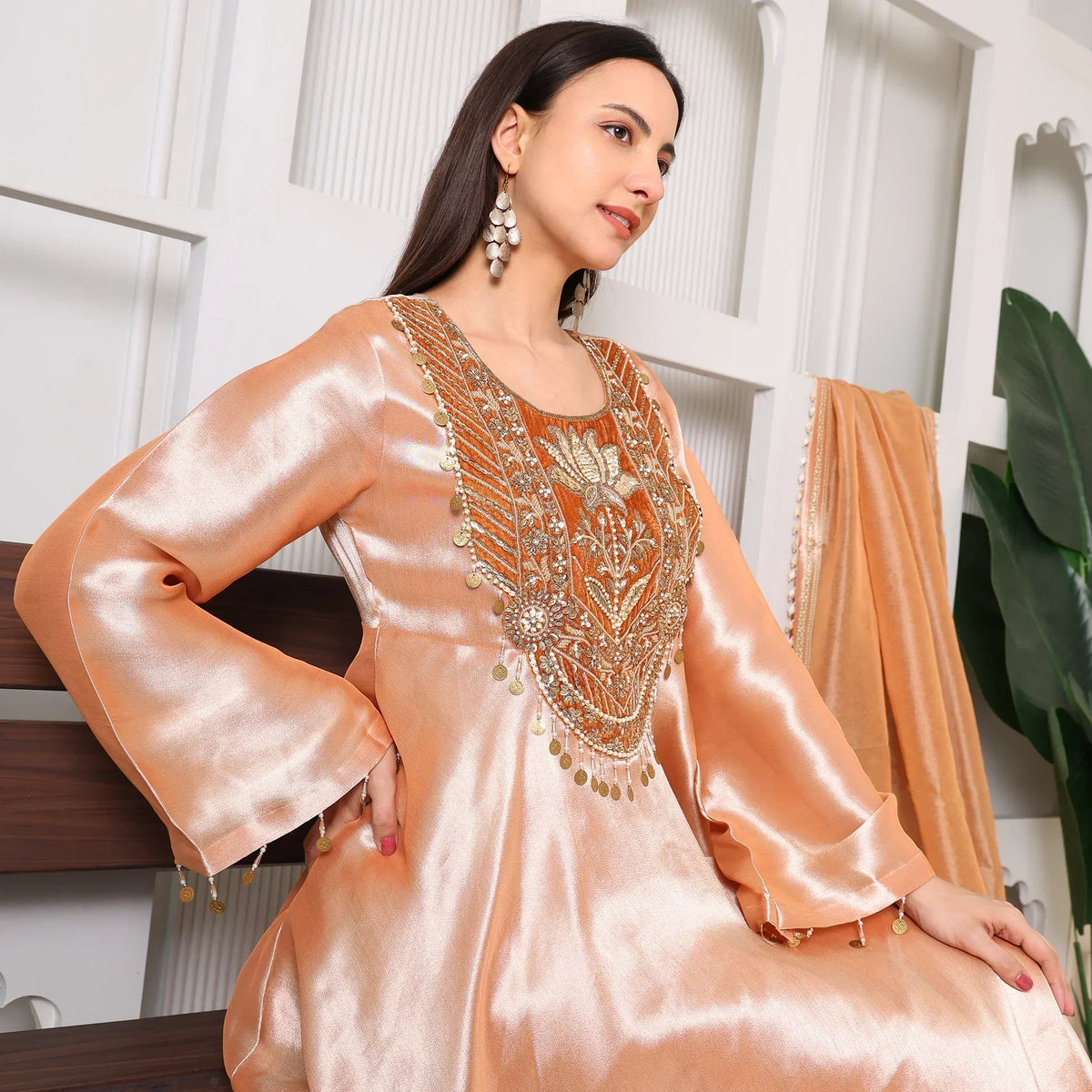 Woman wearing peach Banarasi Anarkali suit with intricate gold embroidery, festive ethnic wear