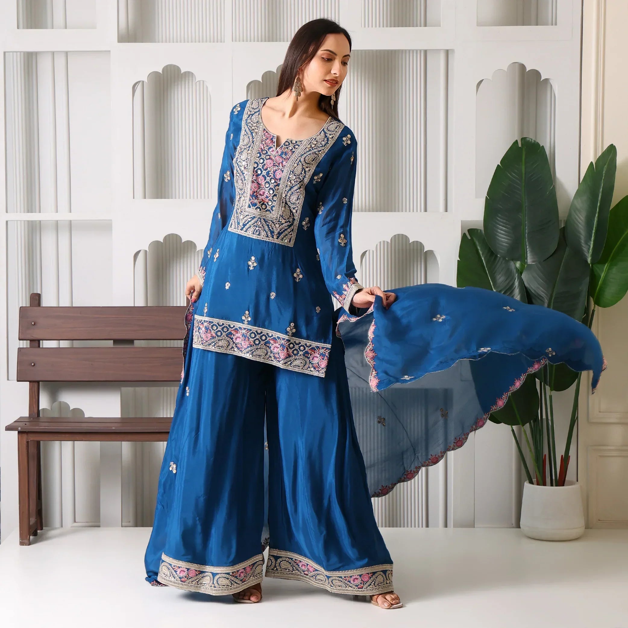 Woman in blue embroidered ethnic suit with palazzo pants and dupatta, festive wear