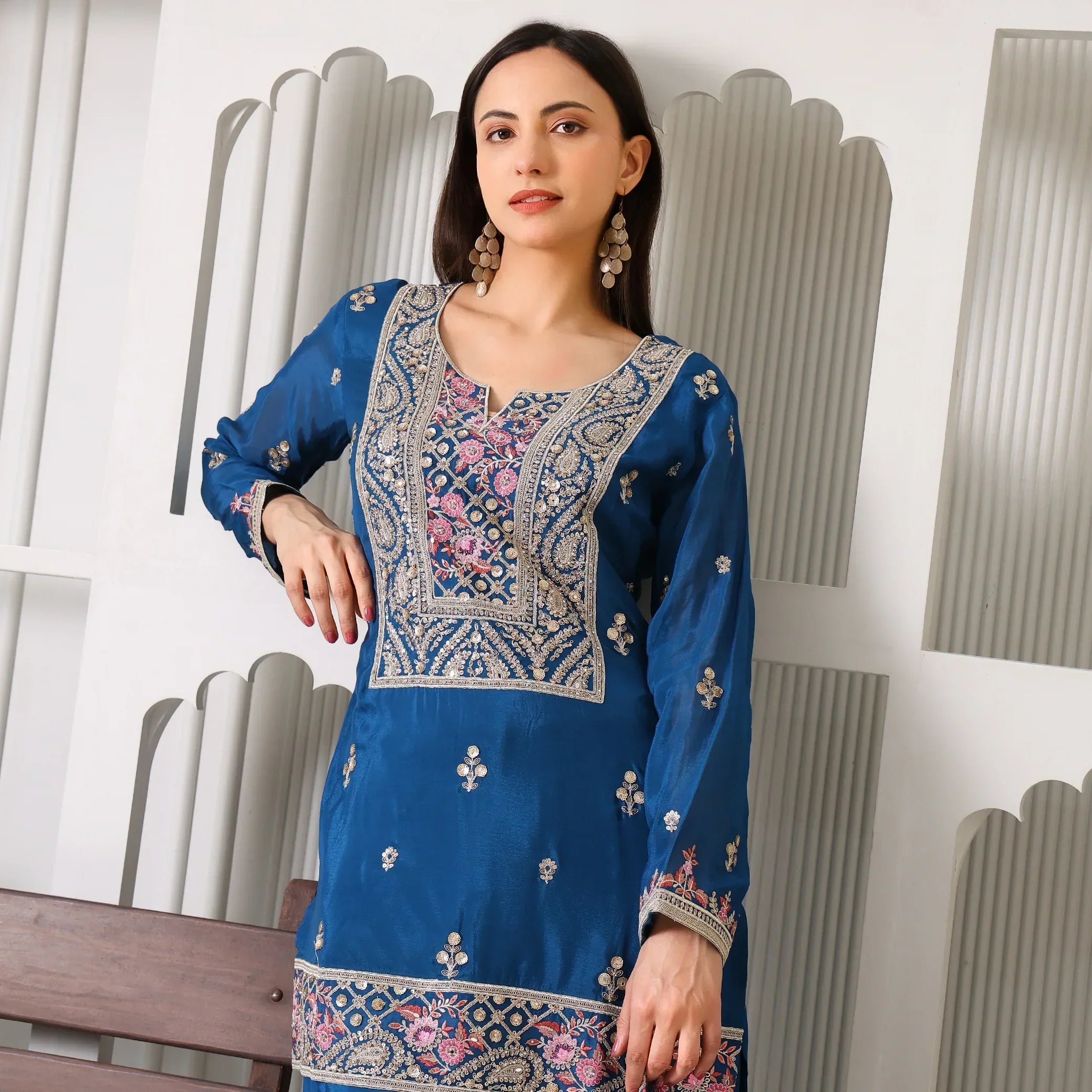 Woman in blue Banarasi Anarkali suit with intricate gold and pink embroidery, festive wear