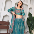 Woman wearing teal embroidered ethnic three-piece suit with floral designs, festive wear