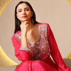 Woman in a pink Banarasi Anarkali suit with intricate silver embroidery, festive wear