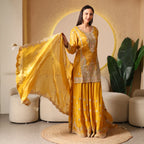 Woman wearing a mustard yellow embroidered Anarkali suit with dupatta, festive ethnic wear