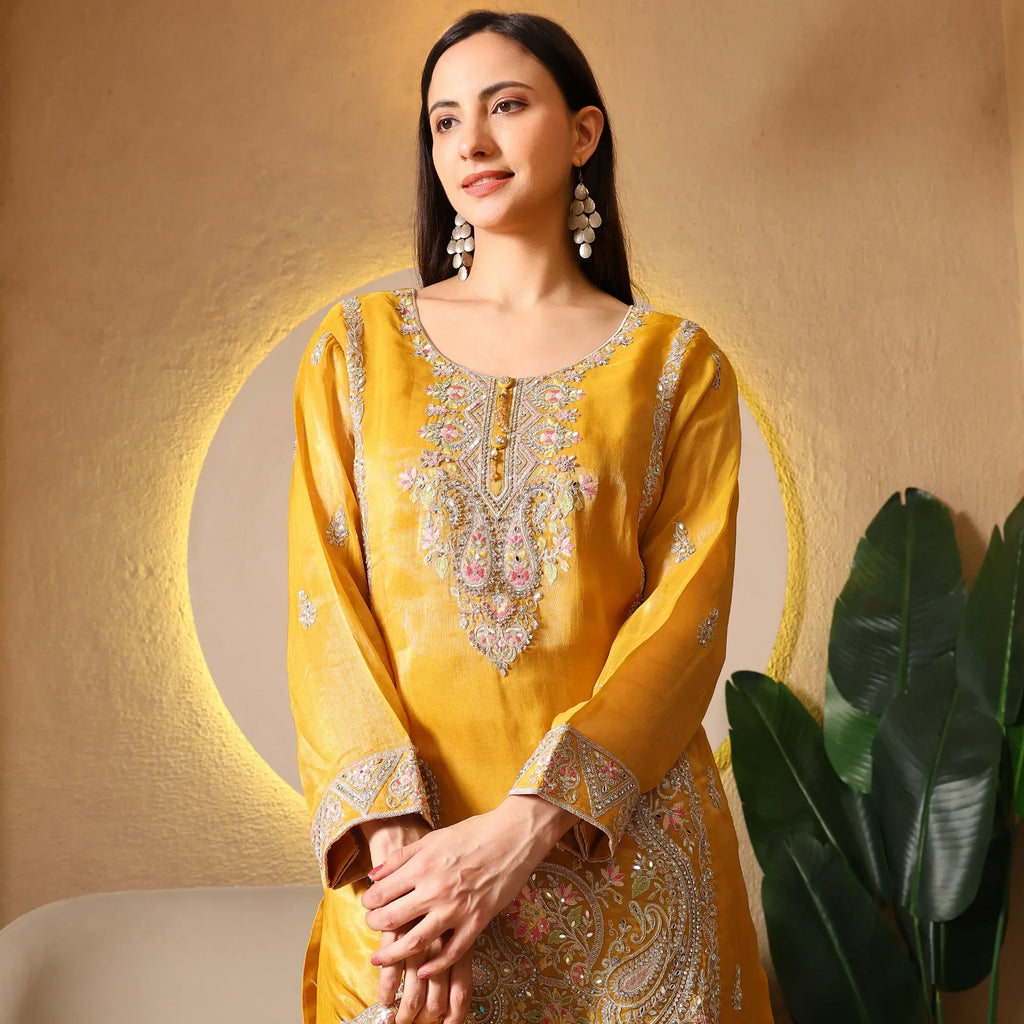Woman in mustard yellow embroidered ethnic kurta with floral detailing, festive wear
