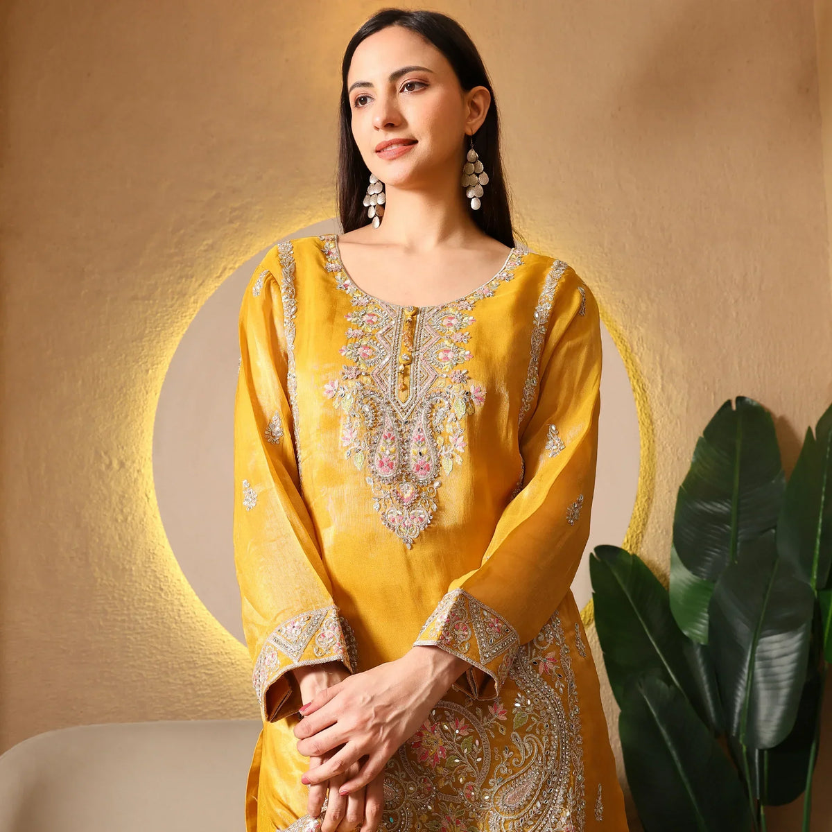 Woman in mustard yellow embroidered ethnic kurta with floral detailing, festive wear