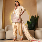 Woman in cream embroidered ethnic salwar suit with dupatta, festive wear