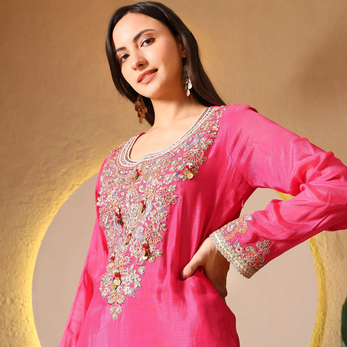 Woman wearing a pink embroidered ethnic kurta for festive and wedding occasions