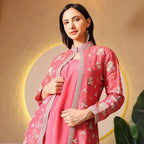 Woman wearing pink embroidered ethnic jacket with floral motifs, festive outfit indoors