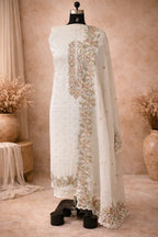 Ivory ethnic suit set with colorful floral embroidery and scalloped dupatta on mannequin