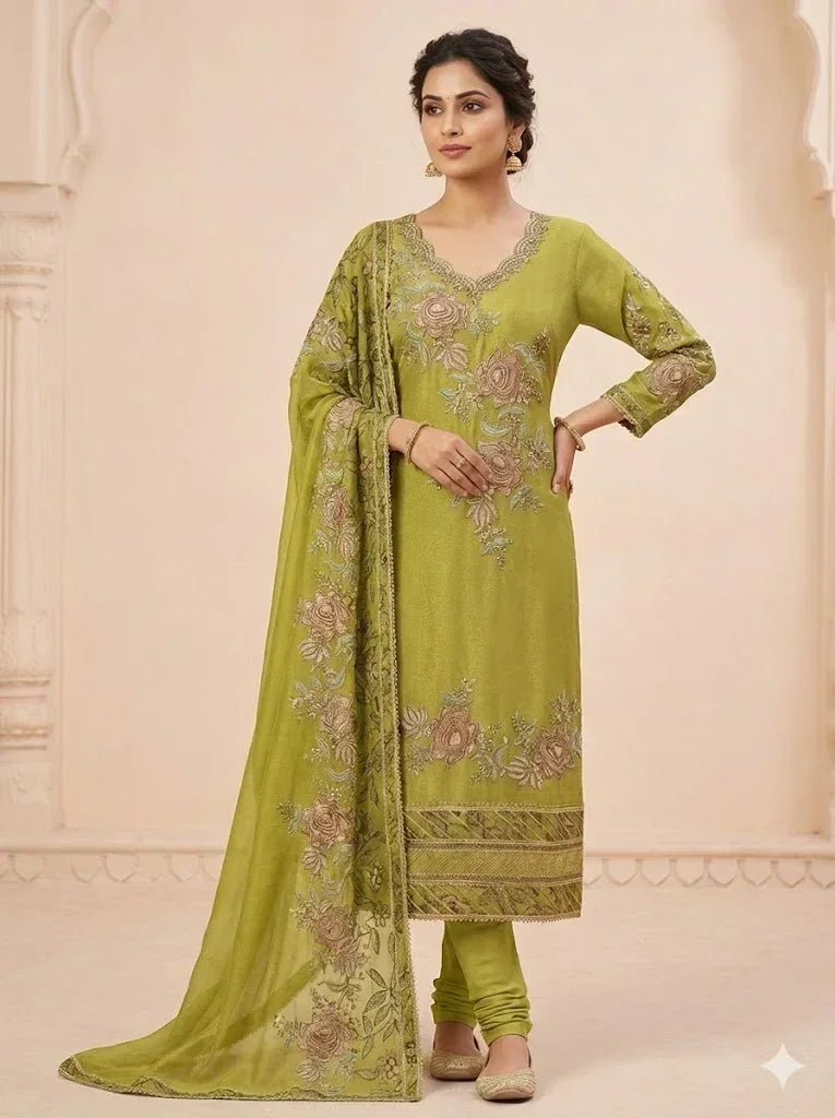 Woman wearing a green embroidered ethnic suit with floral dupatta and churidar pants