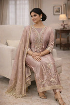Woman in pastel embroidered Anarkali suit with dupatta, posing indoors, festive ethnic wear