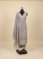 Lavender embroidered ethnic suit set with floral detailing, dupatta, and pants on mannequin