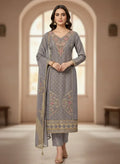 Woman wearing grey embroidered ethnic suit with dupatta, traditional festive outfit