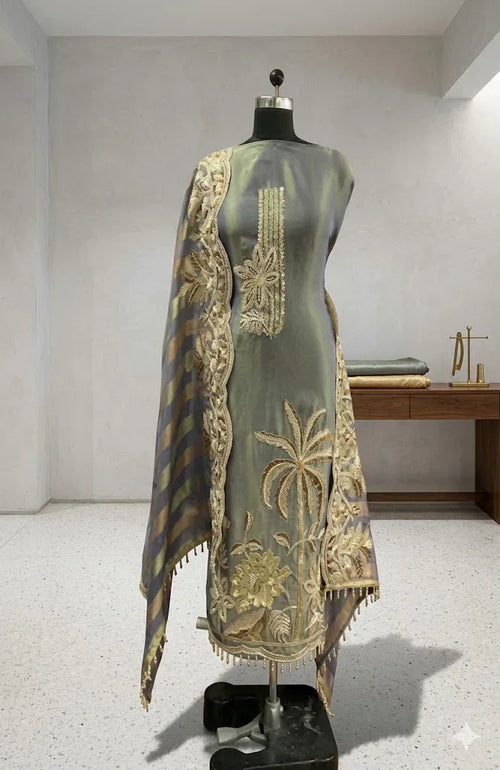 Elegant grey ethnic suit with golden floral embroidery and striped dupatta displayed on mannequin