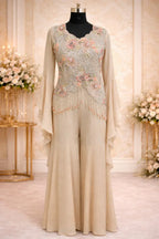 Beige designer ethnic jumpsuit with floral embroidery and flared sleeves on mannequin