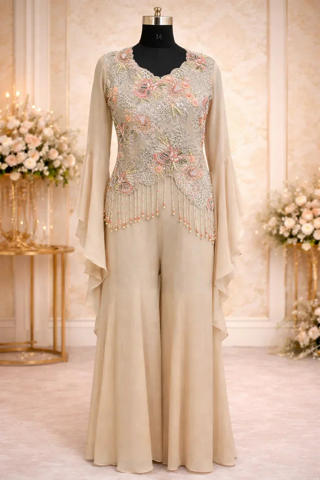 Beige designer ethnic jumpsuit with floral embroidery and flared sleeves on mannequin