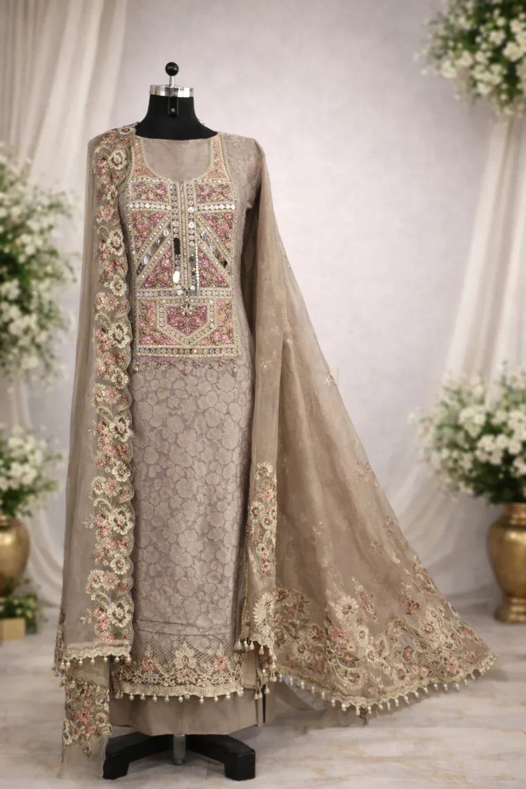 Designer beige embroidered Anarkali suit with floral patterns and embellished dupatta