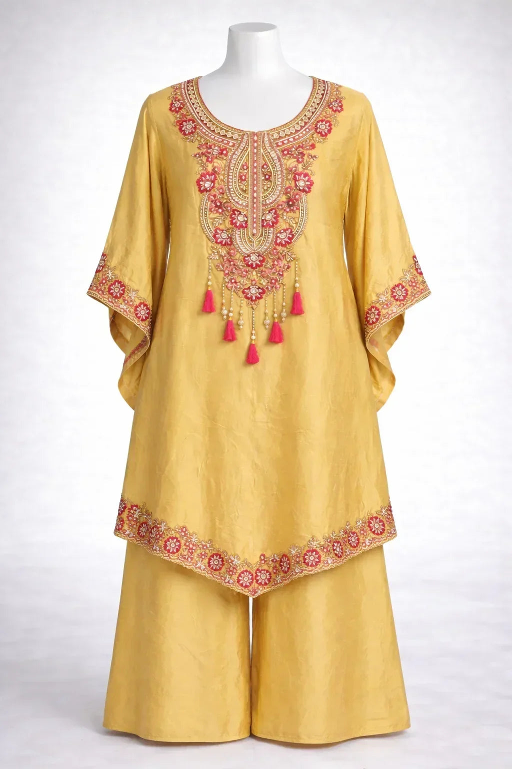 Yellow ethnic kurta palazzo set with floral embroidery and pink tassel details