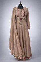 Embroidered beige Anarkali suit with dupatta, intricate neckline and traditional Indian design