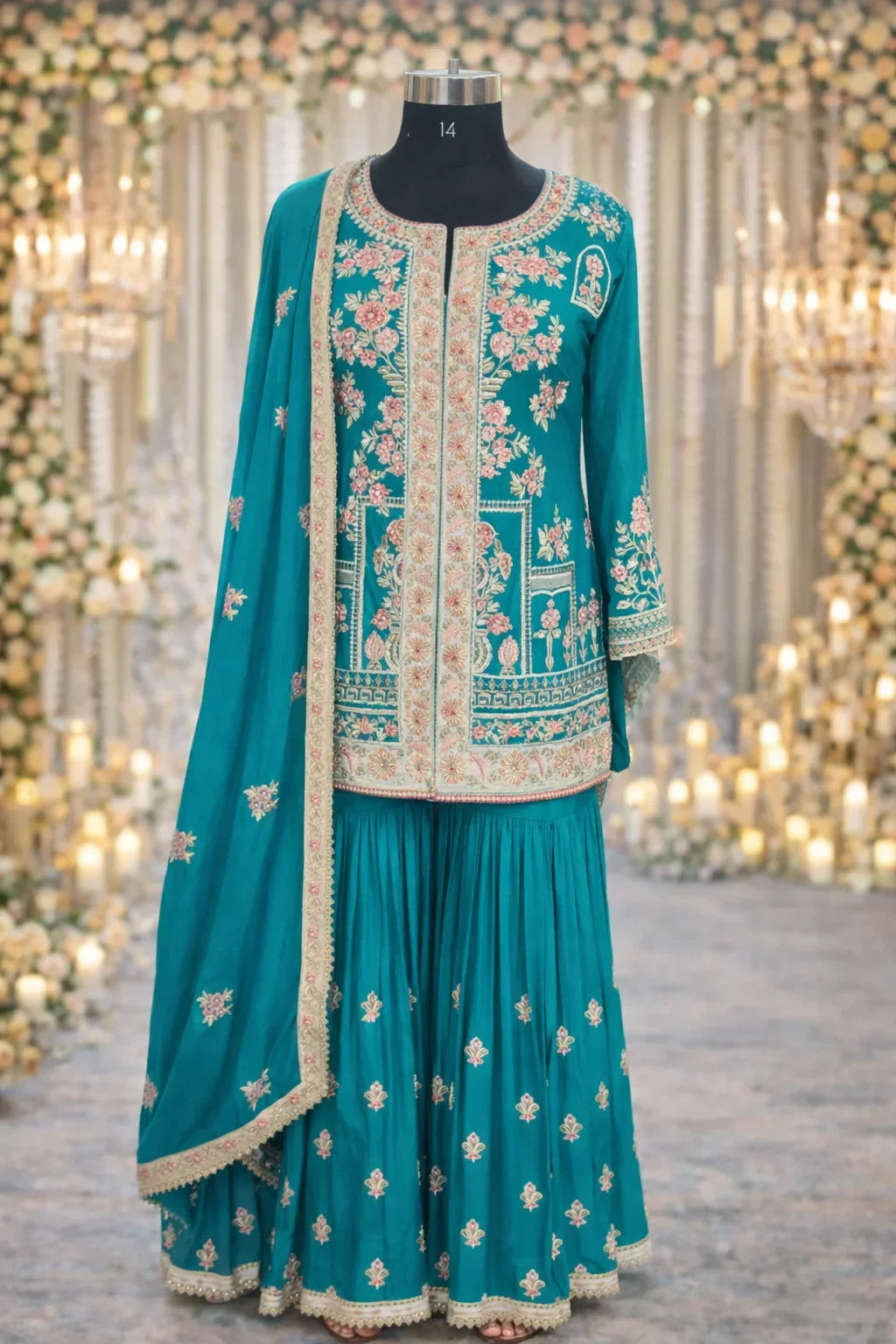 Teal ethnic Anarkali suit with floral embroidery, dupatta, and pleated skirt, perfect for weddings
