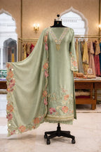 Sage green ethnic Anarkali suit with floral embroidery and dupatta, displayed on mannequin