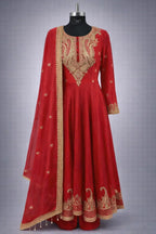 Red Banarasi Anarkali suit with intricate gold embroidery, dupatta, and festive detailing