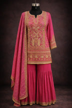 Pink designer ethnic sharara suit with gold embroidery and dupatta, displayed on mannequin