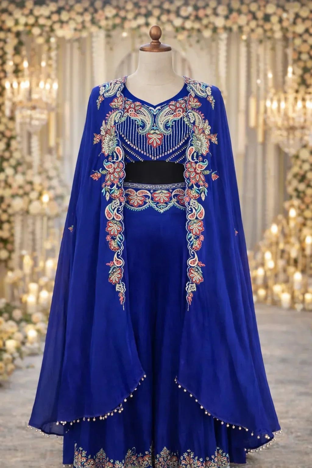 Royal blue Anarkali suit with floral embroidery and cape, ideal for weddings or festive occasions