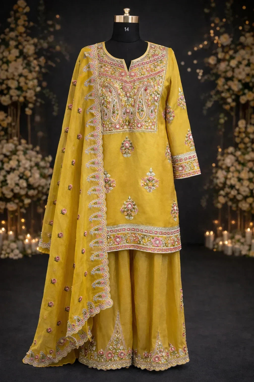 Yellow embroidered ethnic suit with dupatta and floral detailing, displayed on mannequin