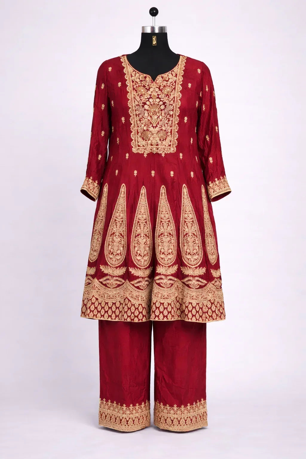 Red Banarasi Anarkali suit with gold embroidery, three-quarter sleeves, and matching pants