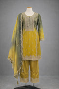 Yellow and green embroidered ethnic suit with matching dupatta and pants on mannequin