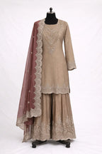 Designer beige ethnic suit with intricate embroidery and maroon dupatta on mannequin