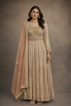 Woman wearing a beige embroidered Anarkali suit with a pink dupatta, ethnic festive outfit