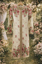 Ivory long sleeve ethnic suit with pink floral embroidery, hanging outdoors in a garden setting.