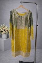 Yellow and green embroidered ethnic kurta with intricate detailing, displayed on hanger