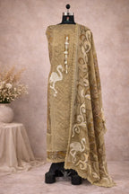 Beige embroidered ethnic suit with intricate patterns and crane motifs on a mannequin
