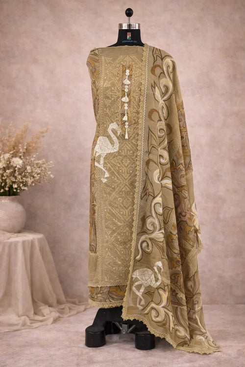 Beige embroidered ethnic suit with intricate patterns and crane motifs on a mannequin