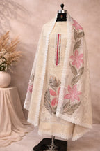 Cream embroidered ethnic suit on mannequin with sheer dupatta, pink floral design, lace border