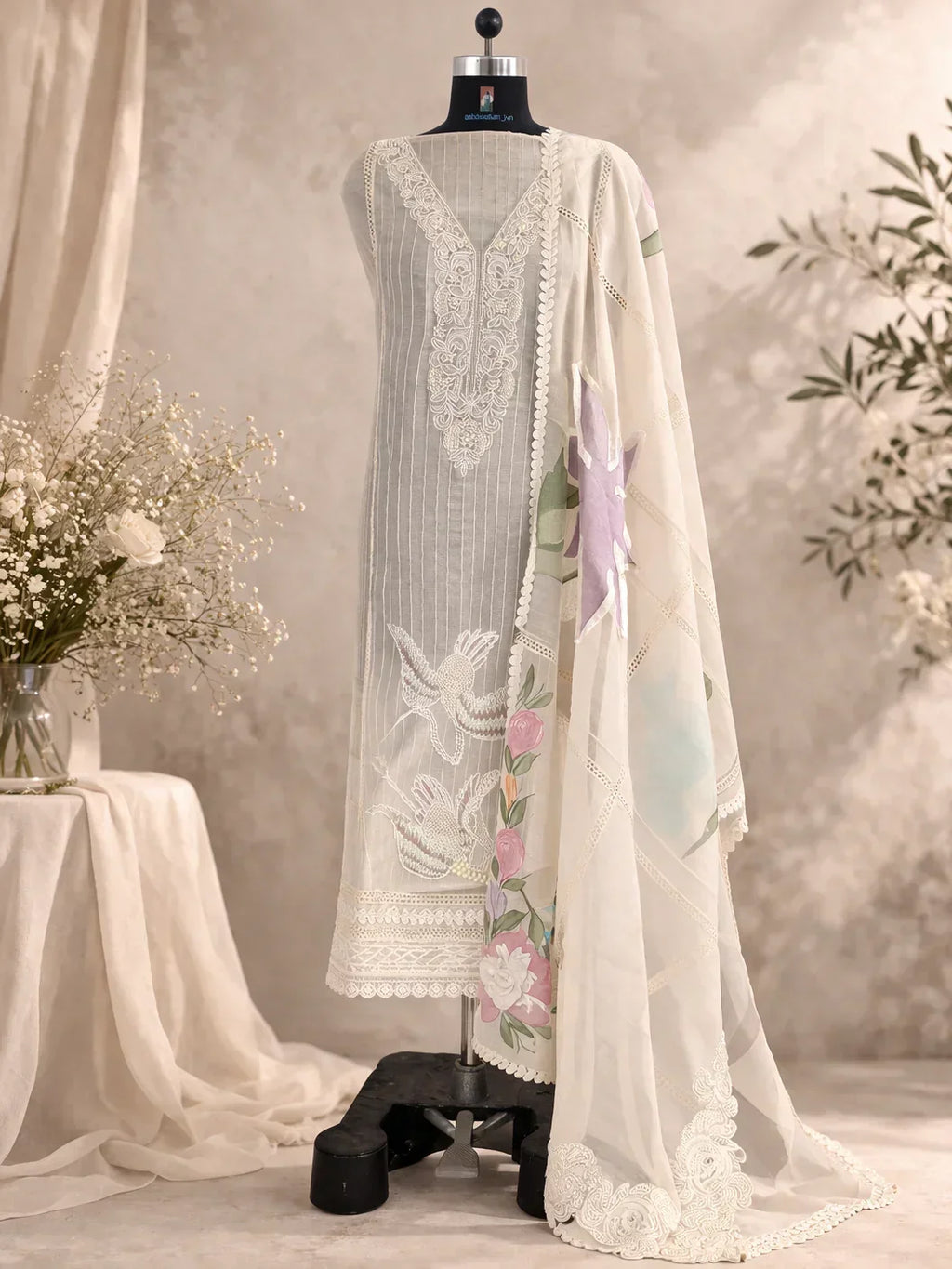 Ivory embroidered ethnic suit with floral dupatta on mannequin, luxury Indian attire