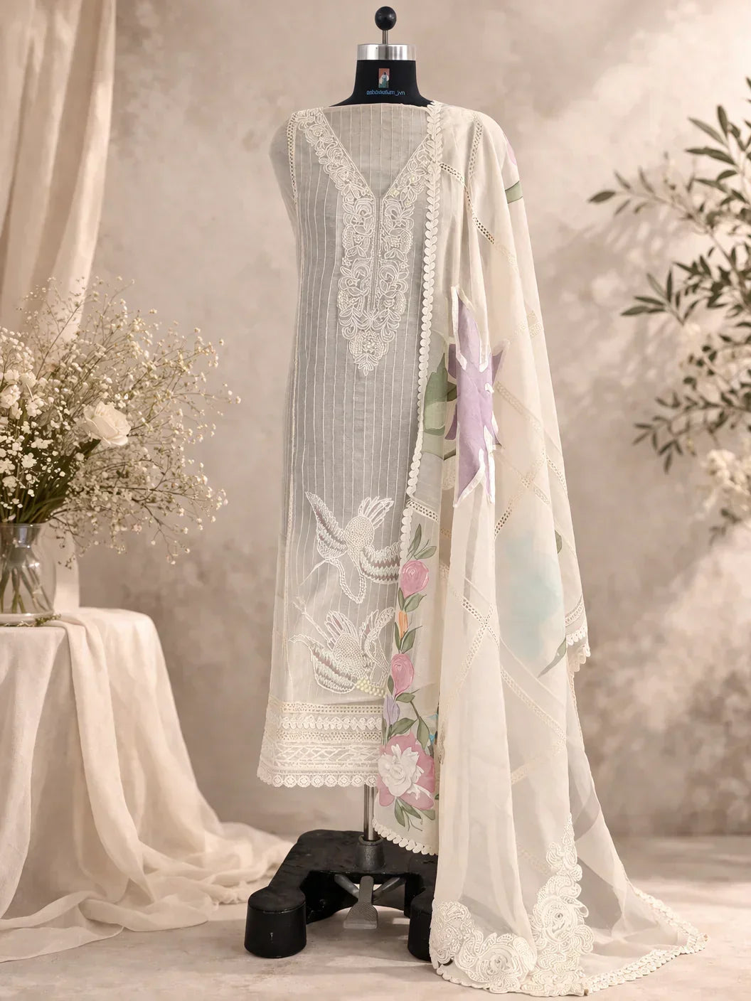 Ivory embroidered ethnic suit with floral dupatta on mannequin, luxury Indian attire