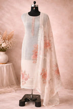 Ivory embroidered Anarkali suit with peach floral dupatta on mannequin, luxury ethnic wear