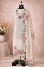 Ivory ethnic suit with sheer floral dupatta and embroidered pink flowers on mannequin