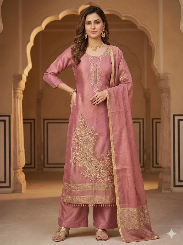 Woman in pink embroidered ethnic suit with dupatta, traditional festive outfit.