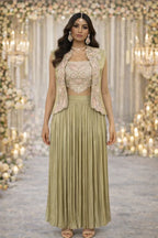 Woman in pastel green embroidered crop top, vest, and long pleated skirt, styled for wedding or festive occasions